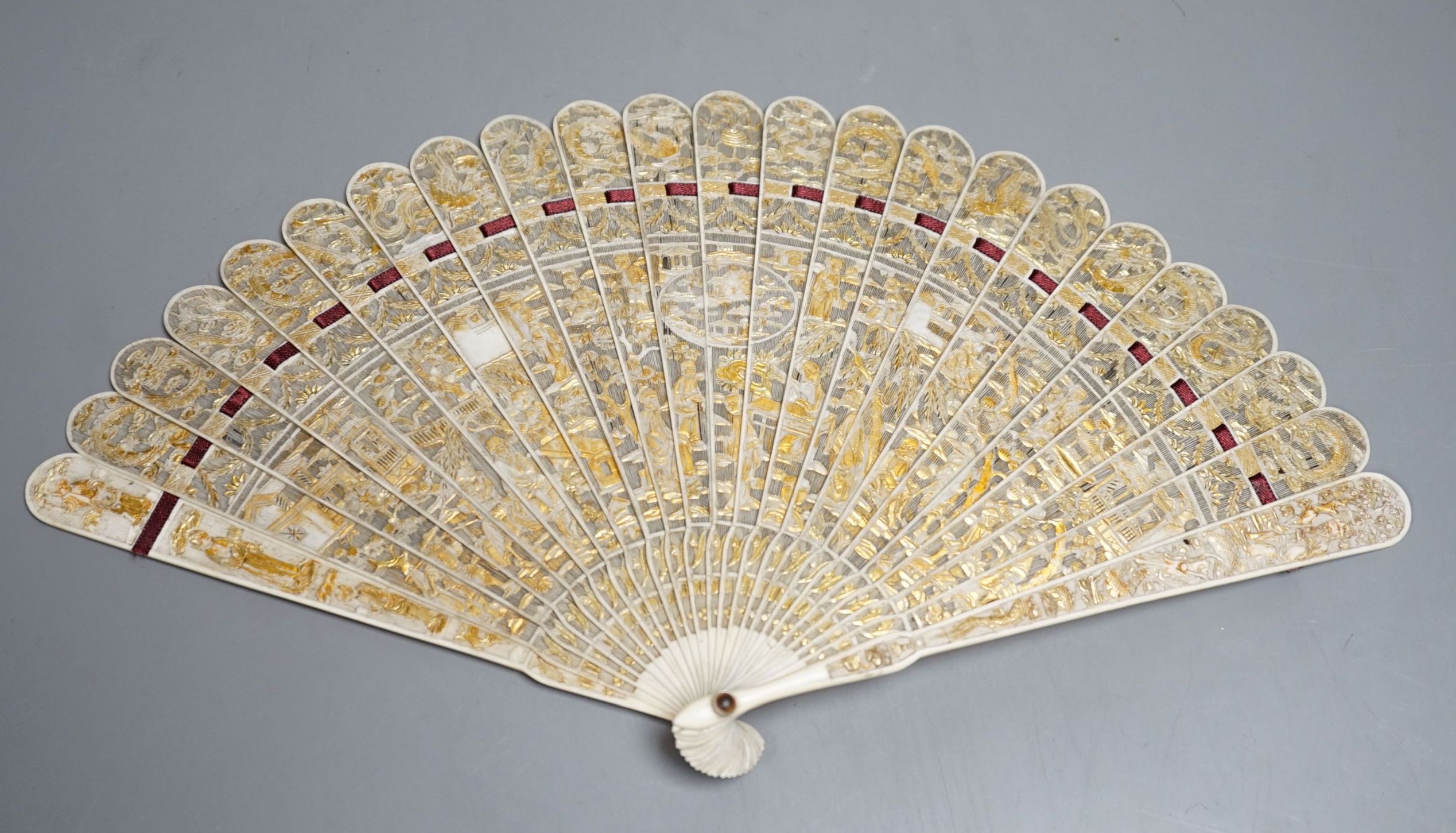 A 19th century Chinese export pierced ivory brise fan, gilded sticks, 19cm